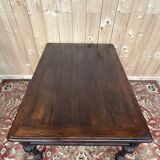 Middle table in a sculpted Louis XIII style living room.