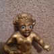 Rare bronze child statuette with blue eyes