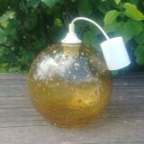 A vintage 70s blown glass pendant light with gold glitter in a globe shape