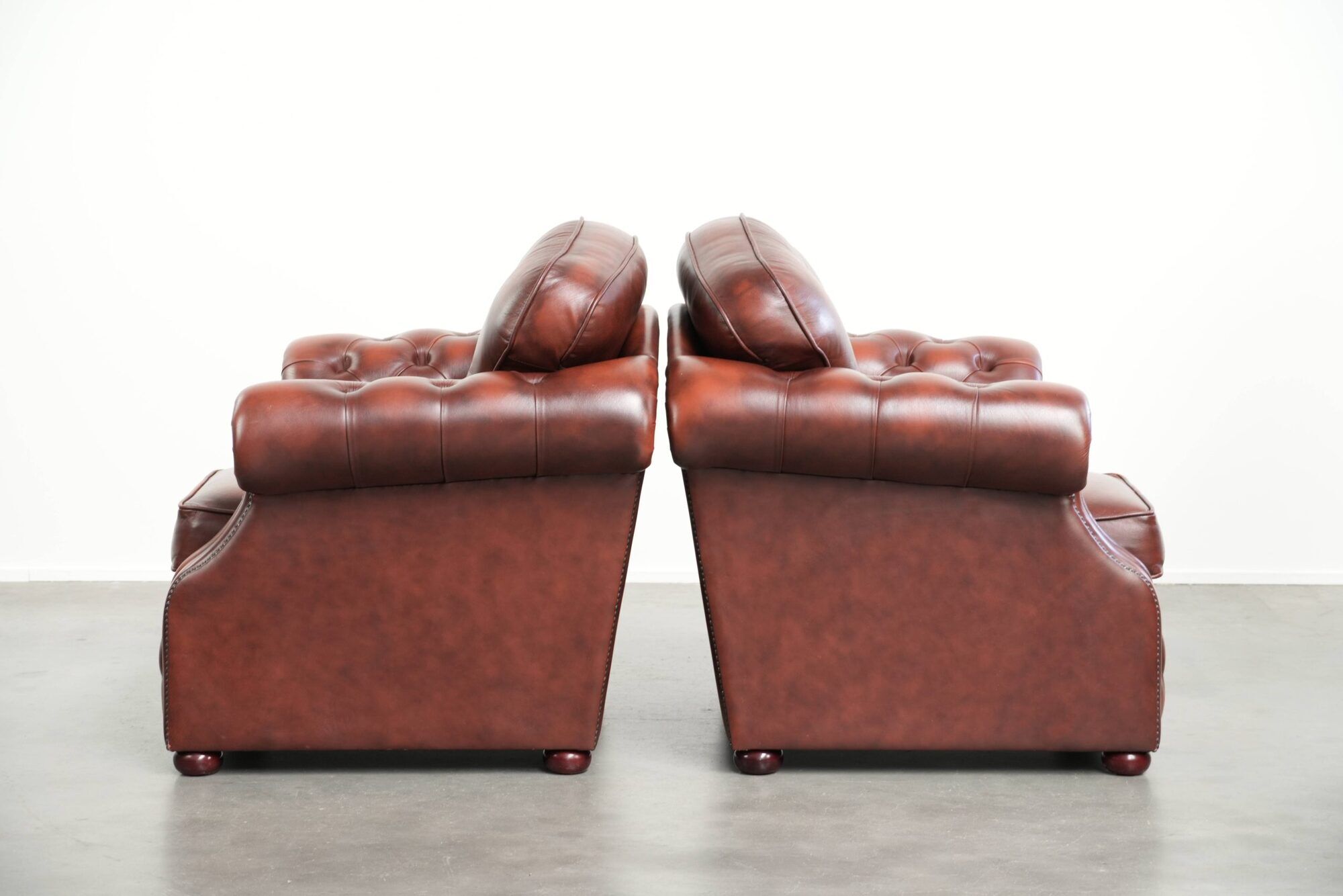 Vintage set of 2 cowhide leather Chesterfield armchairs in a brown colour