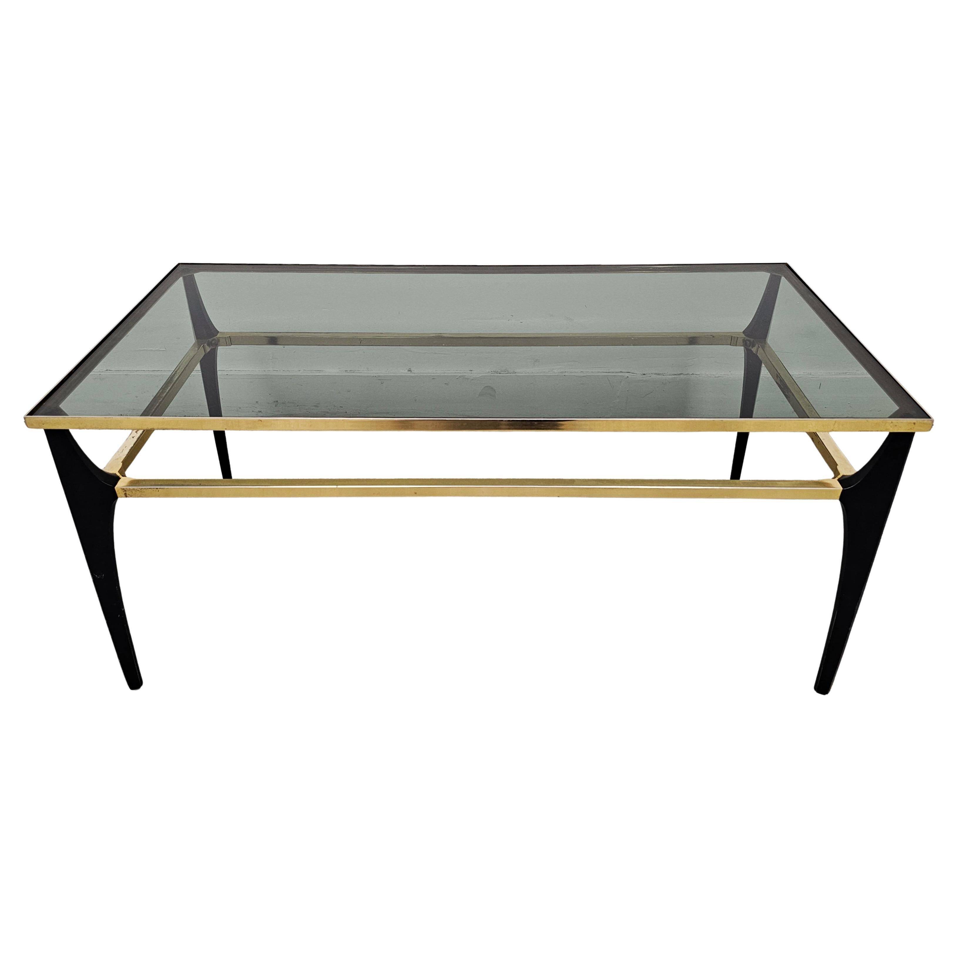 Mid Century Modern coffee table with gold-plated metal and smoked glass.
