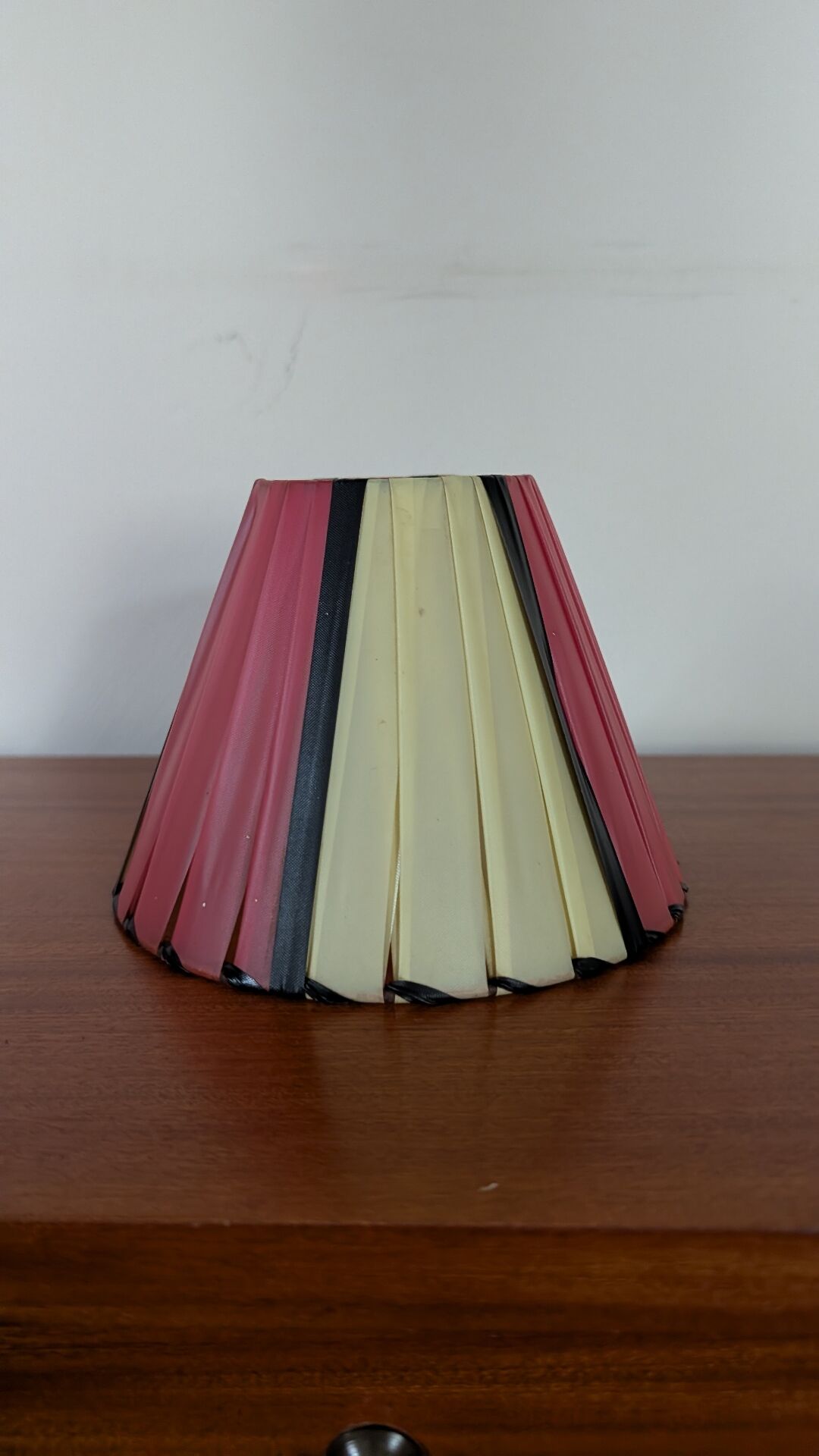 Pleated red and pale yellow plastic conical lampshade from the 1960s.