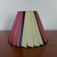 Pleated red and pale yellow plastic conical lampshade from the 1960s.