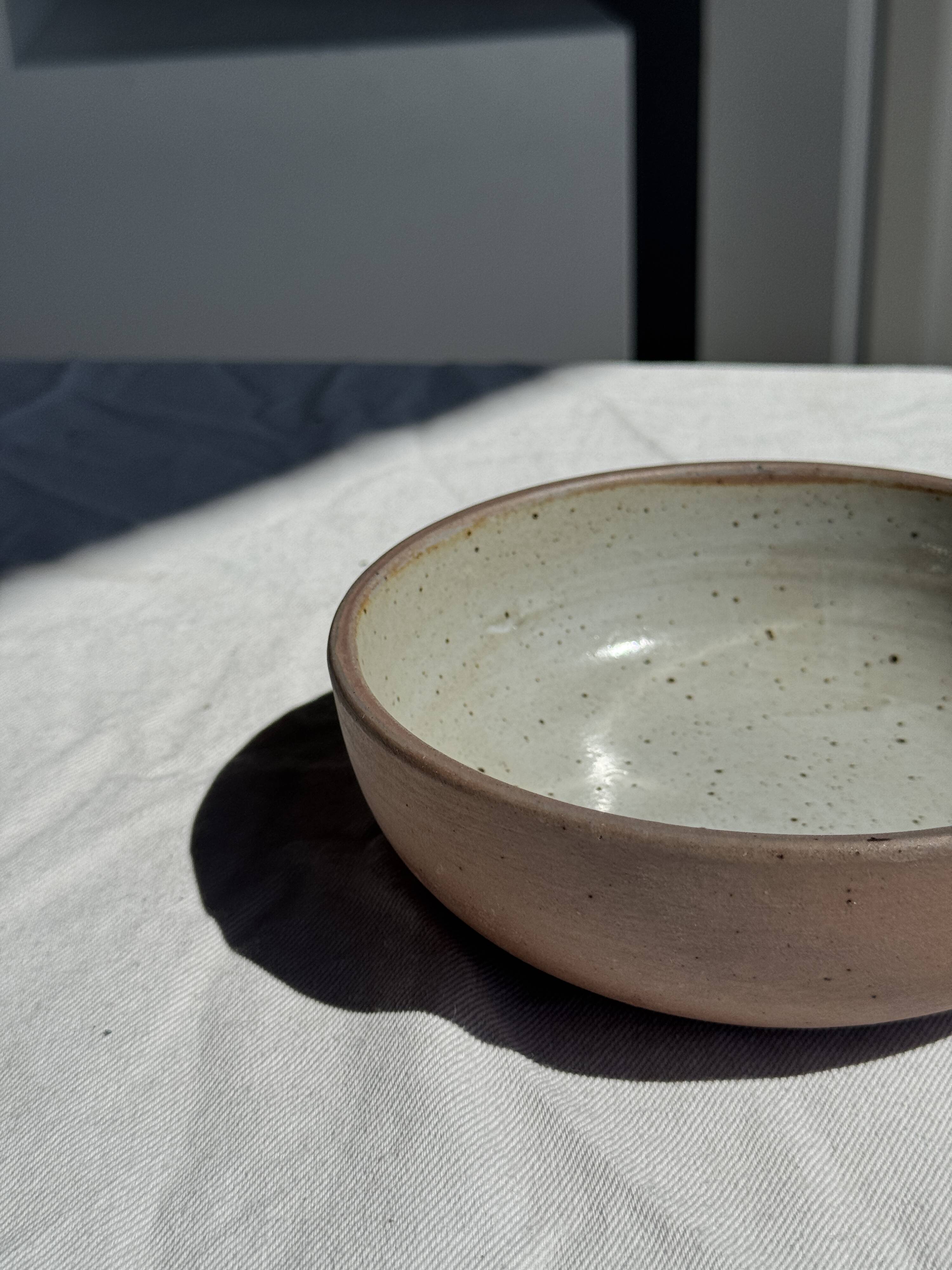 A speckled grey interior bowl with a matte brown exterior H5 D15