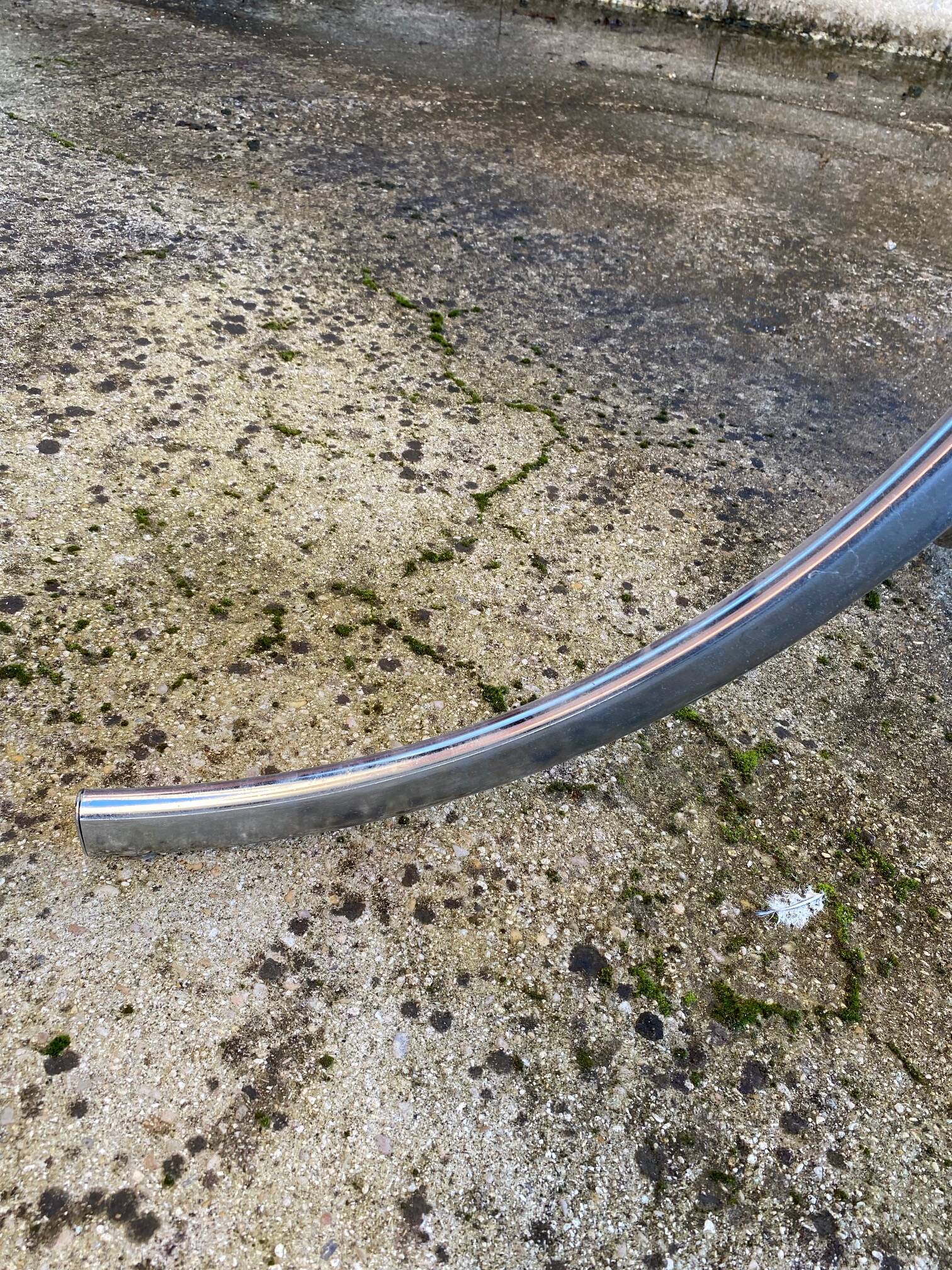 Table with chrome metal legs and smoked glass top.