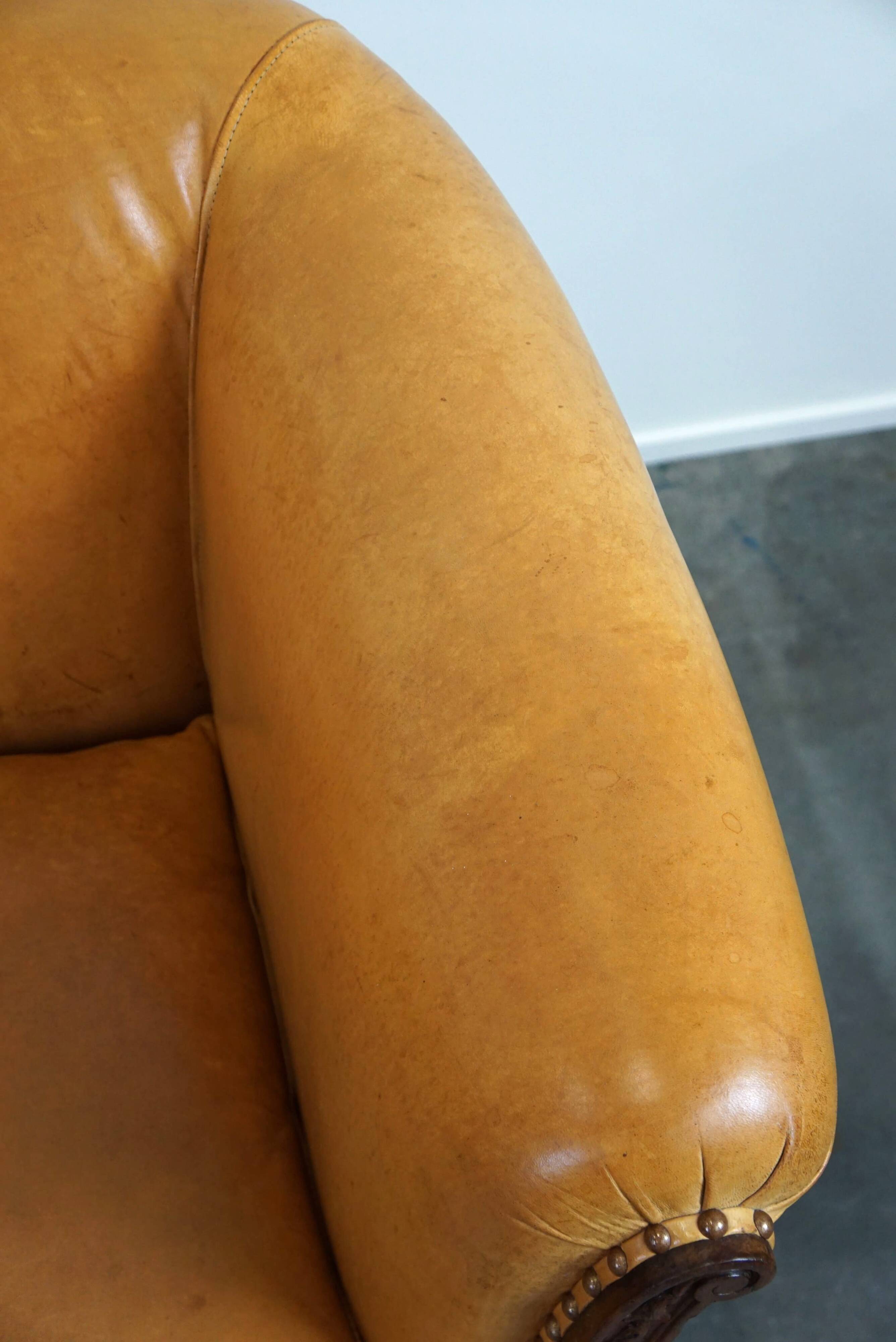 Unique old set of 2 club armchairs and a couch in cognac-colored leather with wheels