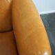 Unique old set of 2 club armchairs and a couch in cognac-colored leather with wheels