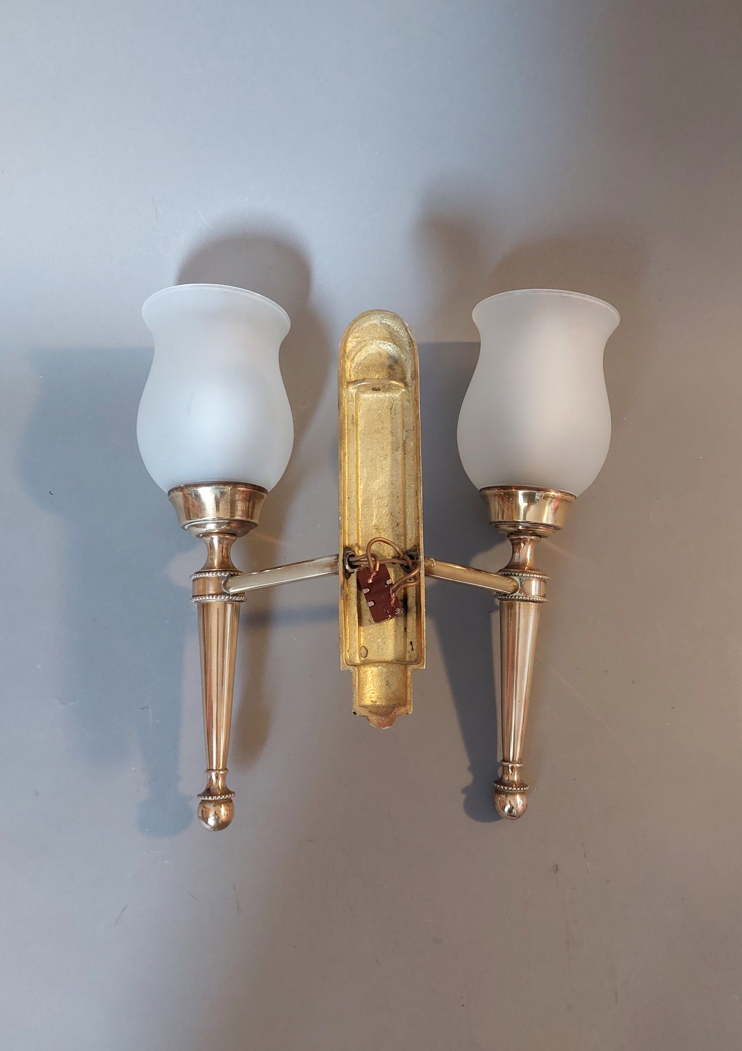 Neoclassical Torch two-arm wall lamp in solid brass, circa 1940