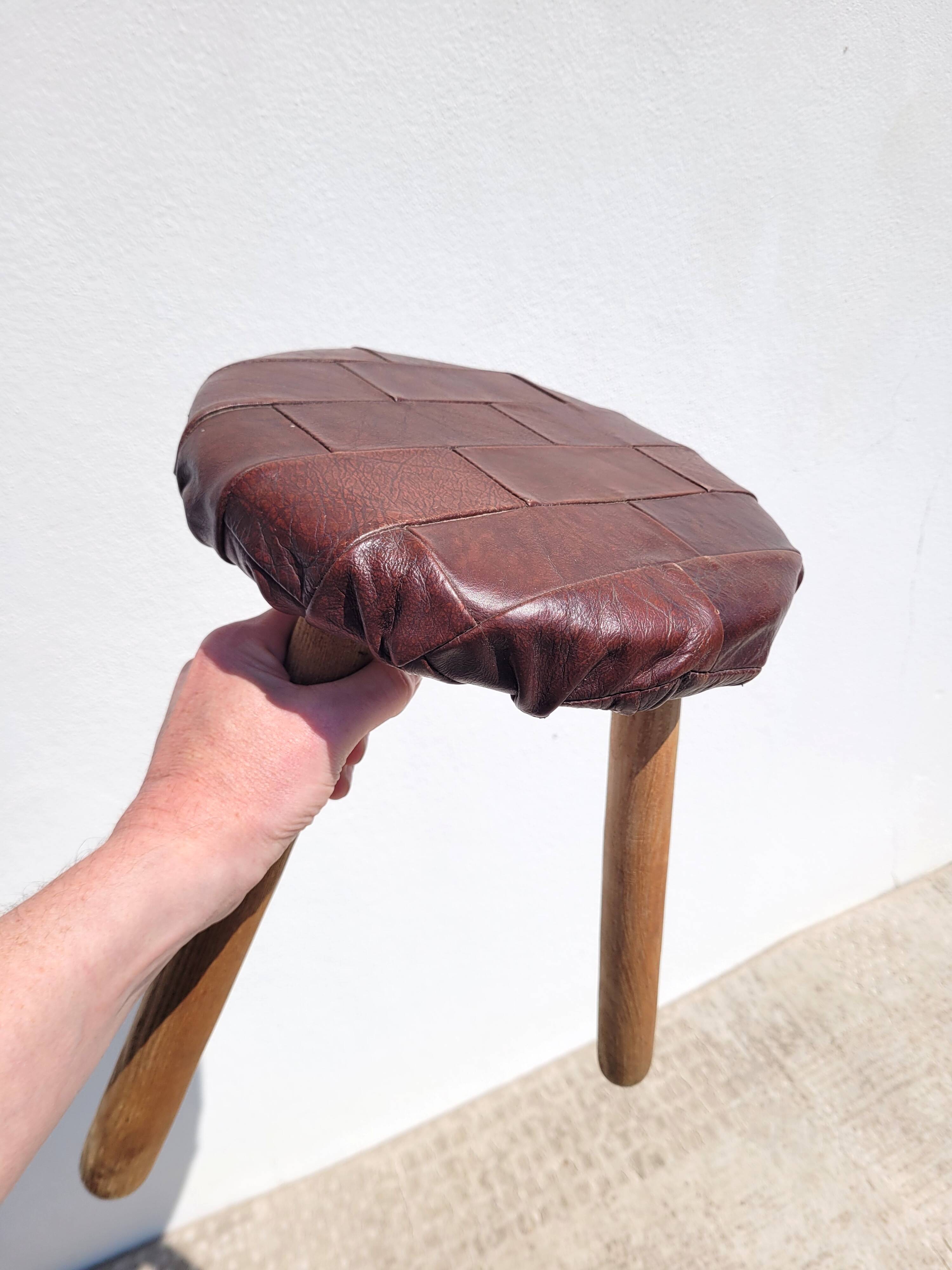 Leather-upholstered tripod stool