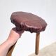 Leather-upholstered tripod stool