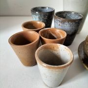 Set of 8 stoneware cups and a mug, shades of beige.
