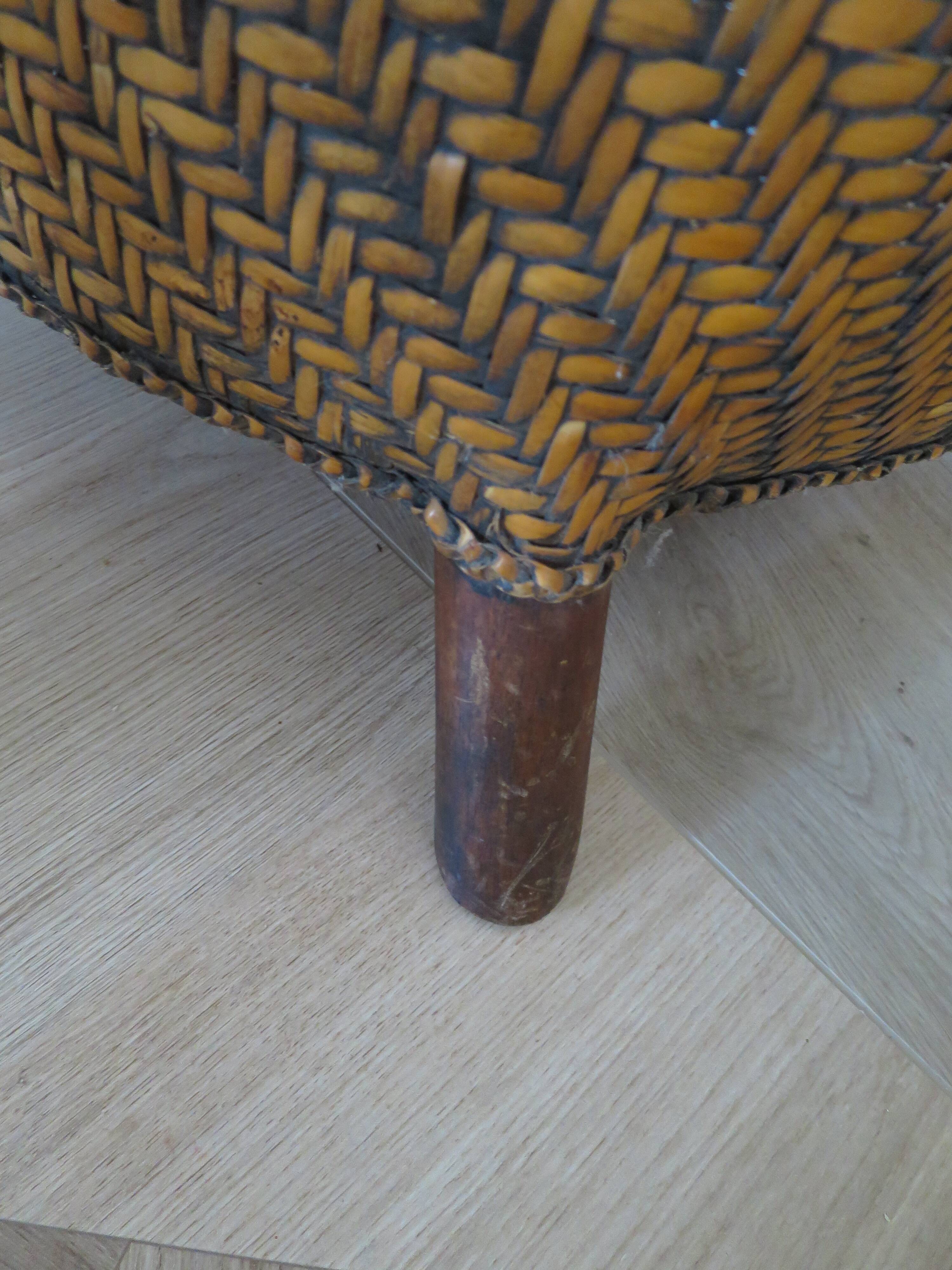 Colonial style armchair in woven rattan and exotic wood
