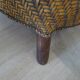 Colonial style armchair in woven rattan and exotic wood