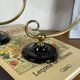 Pair of antique wall sconces with swan necks and glass globes.