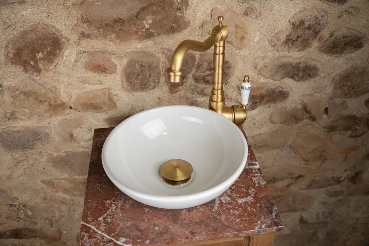 Small antique washbasin in wood and red marble.