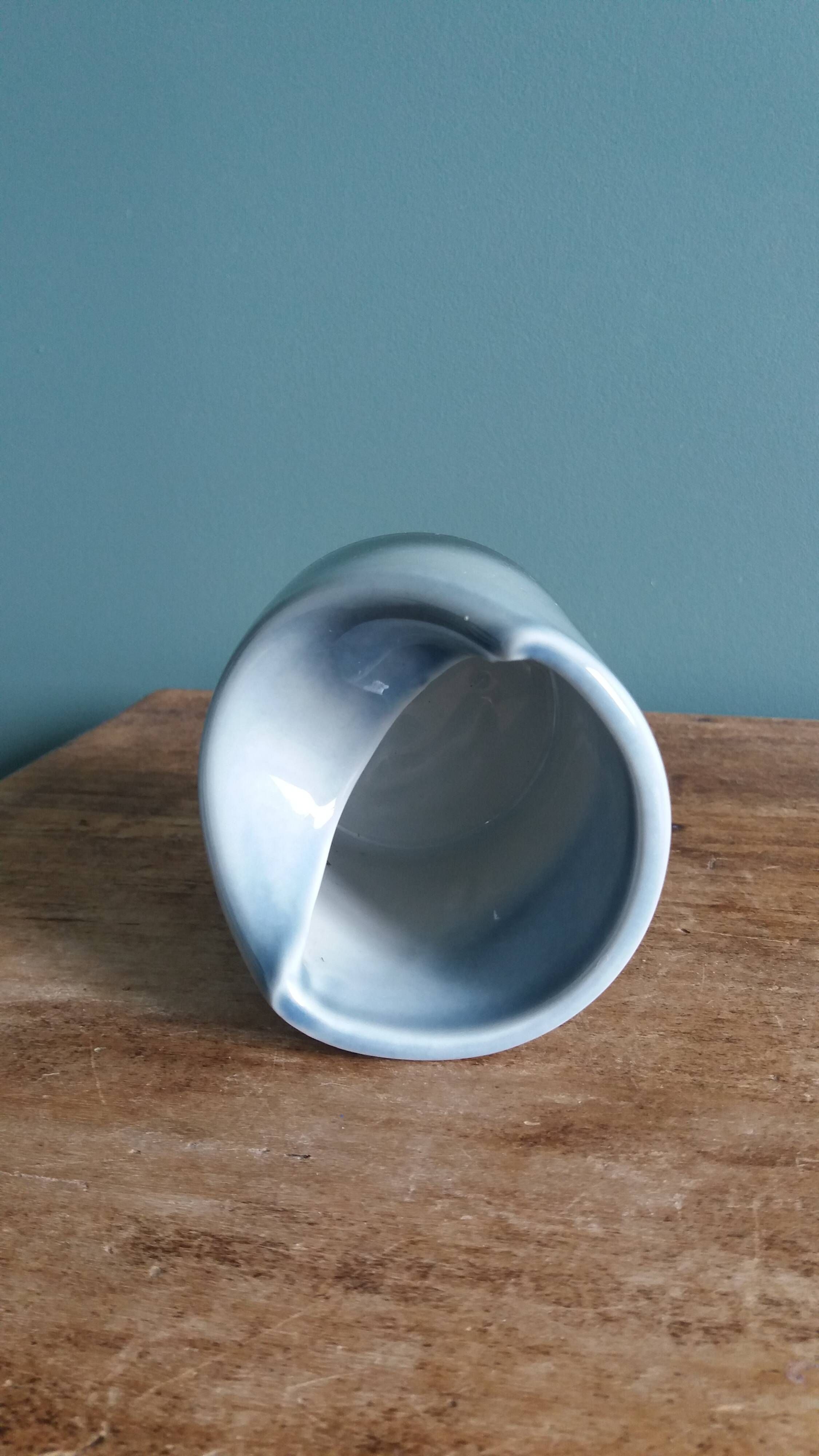 Vase Virebent porcelain cylindrical roll shape with a deep neck.