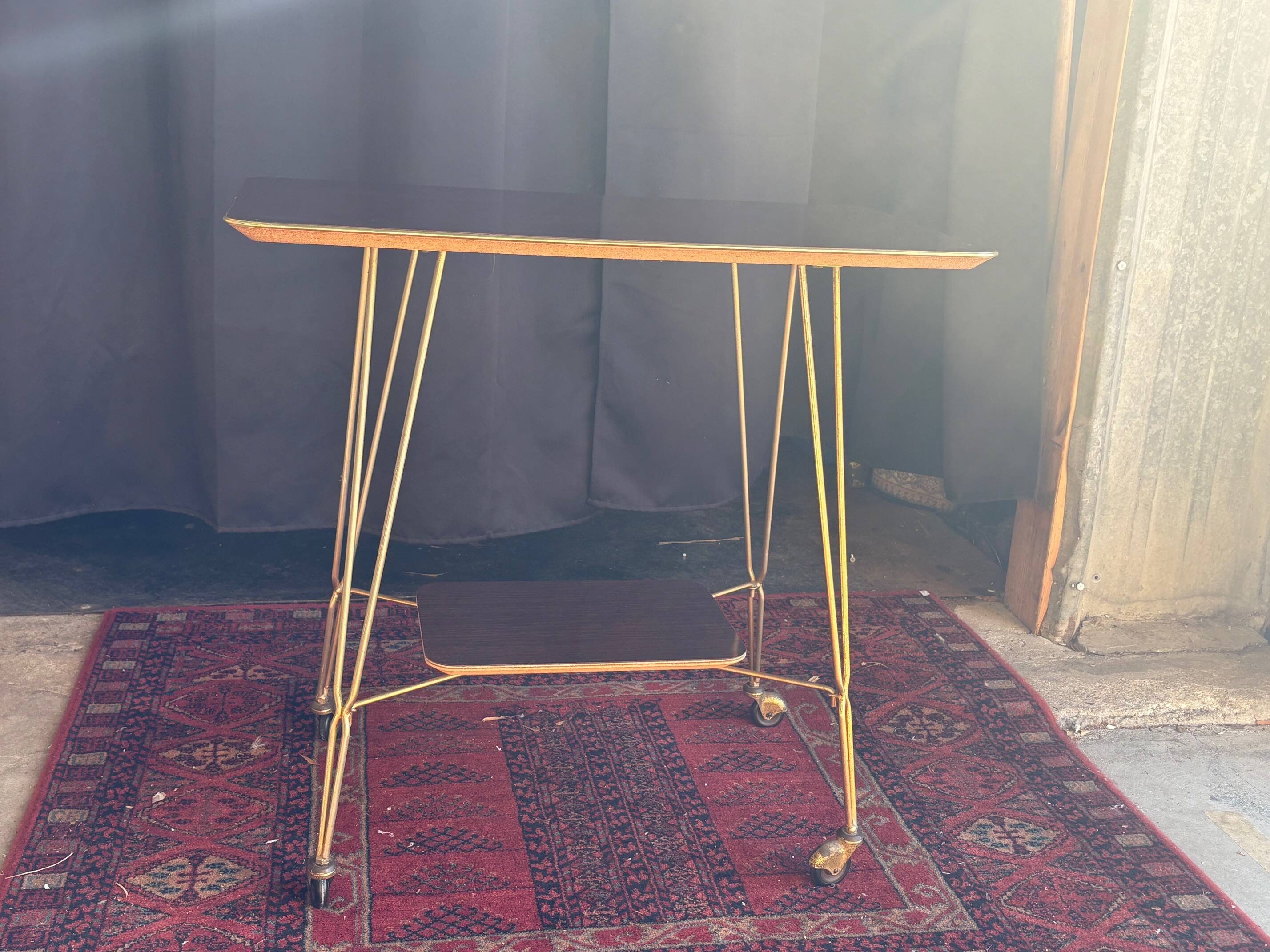Vintage 1960s rolling dessert trolley in gold metal and formica.