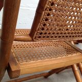 Pair of folding chairs in bamboo and caning, leather and brass