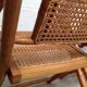 Pair of folding chairs in bamboo and caning, leather and brass