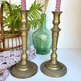 Pair of old candle holders in golden brass