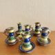Many old glazed terracotta candlesticks.