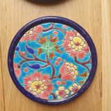 Trivet and Longwy enamel bottle