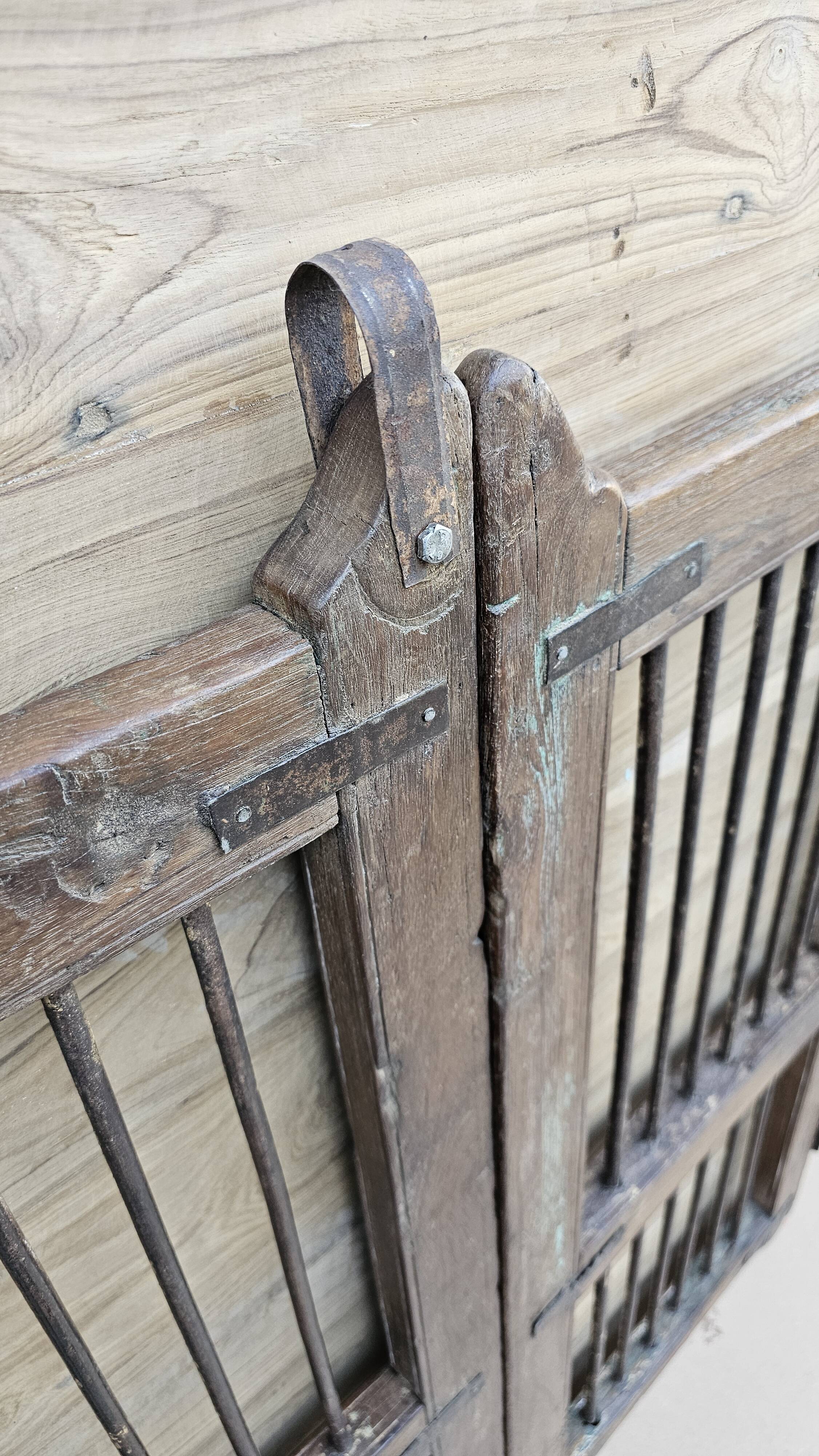 Old gate in Burmese teak and wrought iron