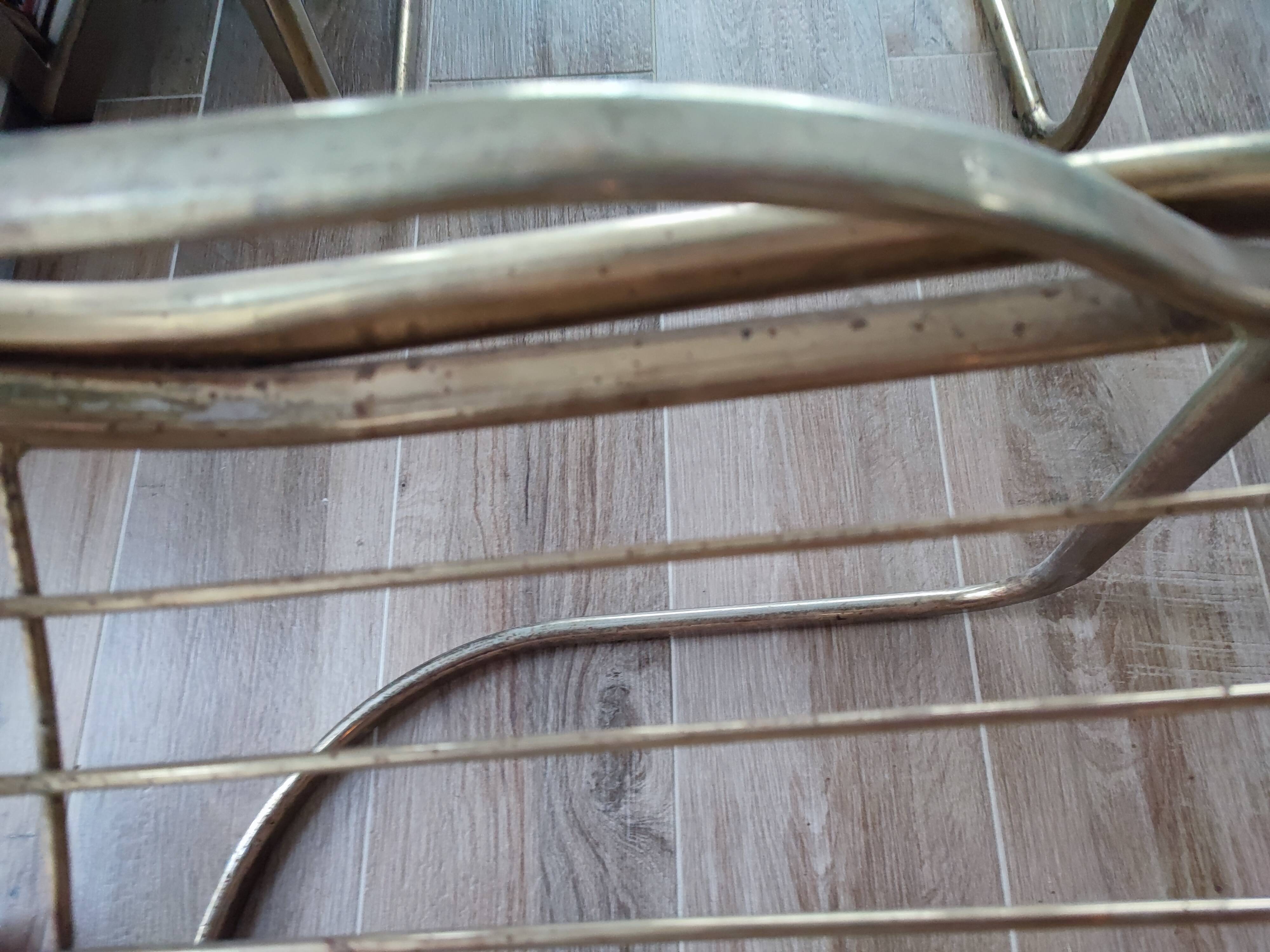 Tubular metal chair covered with gilding