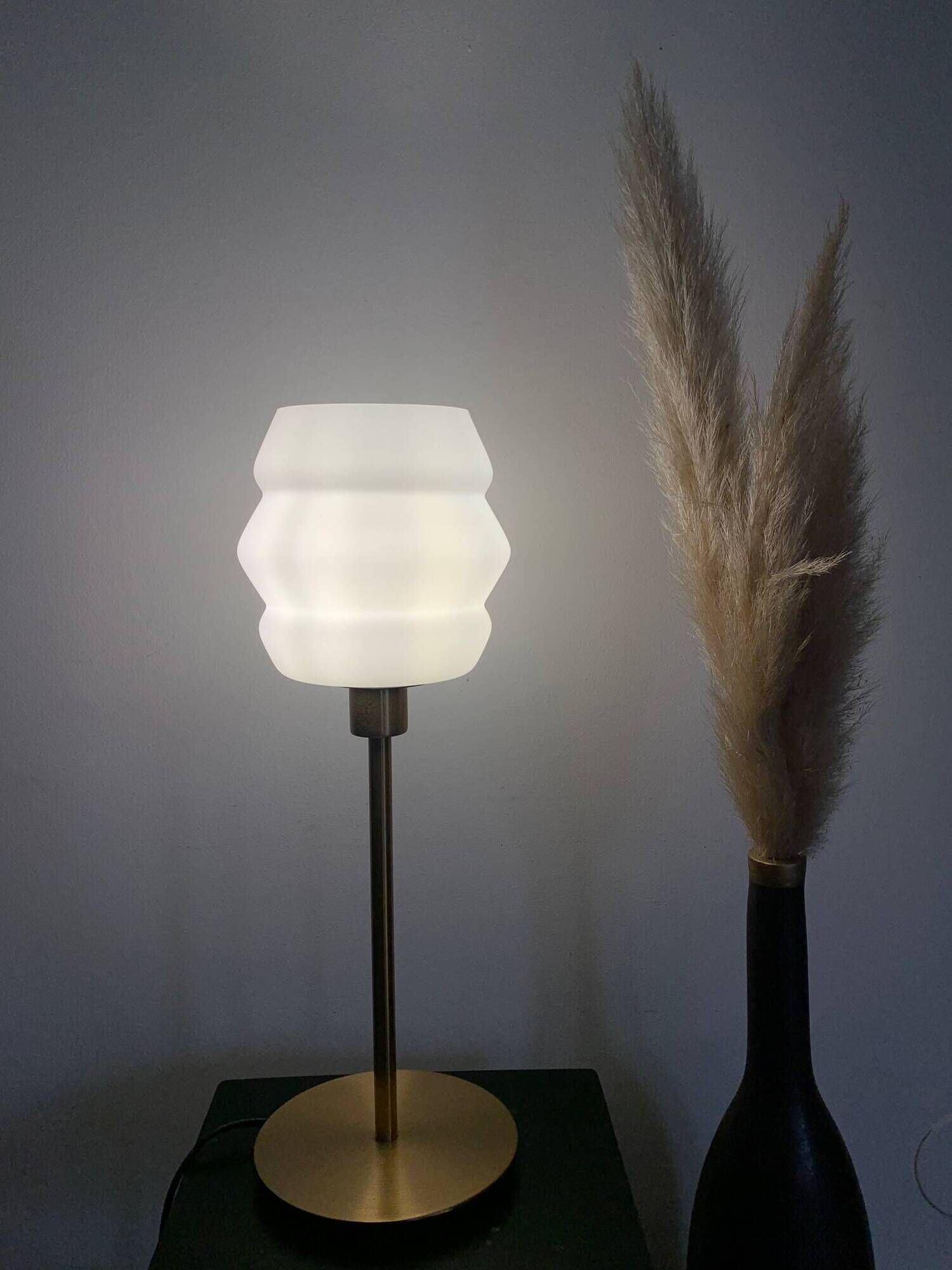 Table lamp with a vintage white glass globe and a golden base