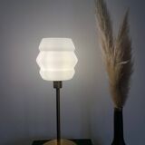 Table lamp with a vintage white glass globe and a golden base