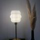 Table lamp with a vintage white glass globe and a golden base