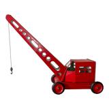 Red sheet metal construction crane dating from the 60s with manual mechanism