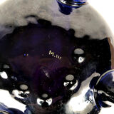 Large earthenware pot cover with enamelled decoration on a blue oven background