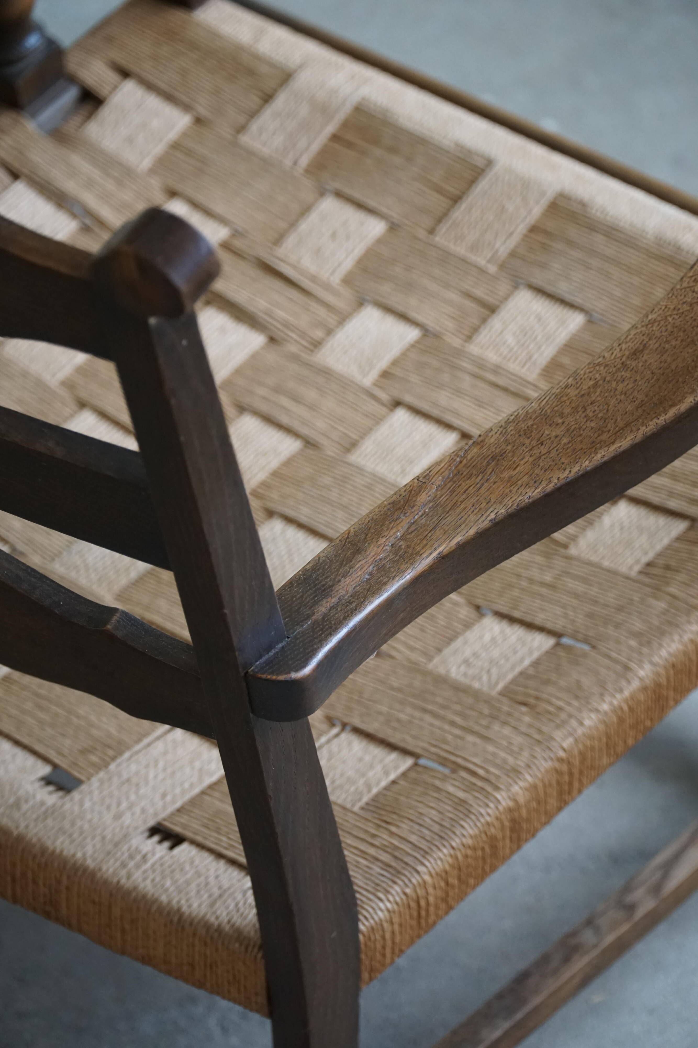 A pair of modern and sculptural vintage Danish armchairs in oak and papercord, 1940s.