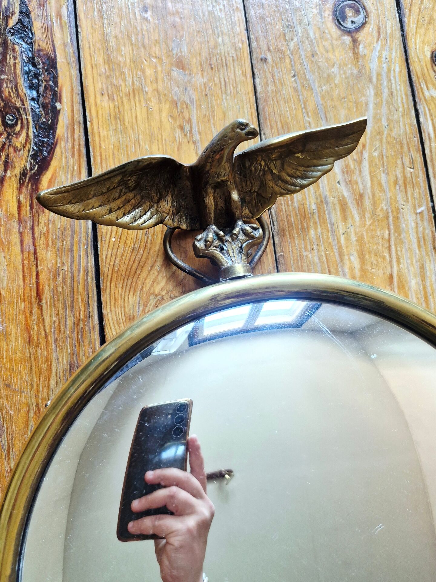 Vintage convex witch mirror with triumphant eagle.