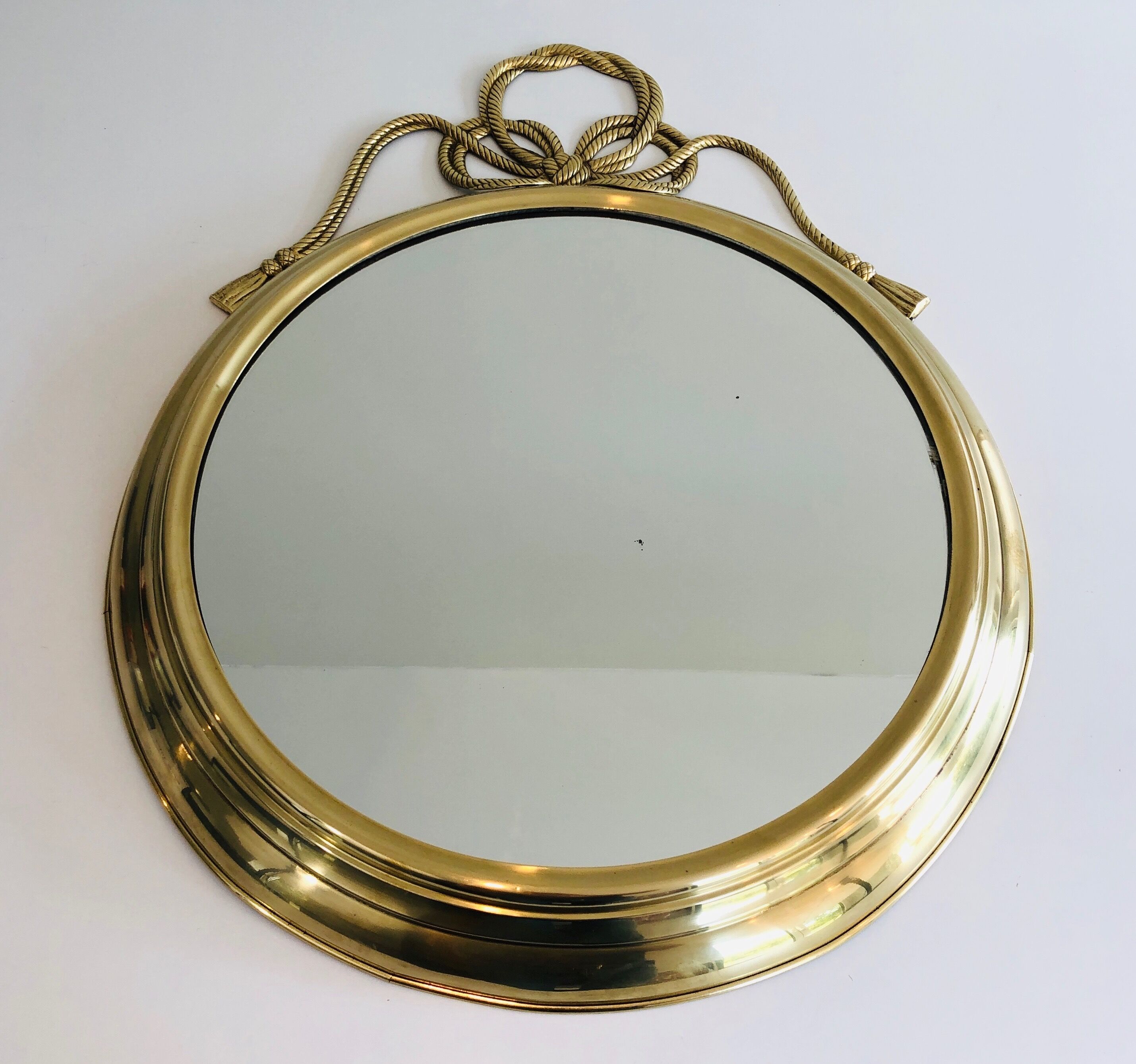 Oval Decorative Mirror in Brass decorated with an Important Twisted Knot