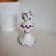 Ceramic candlestick with red and blue decoration.