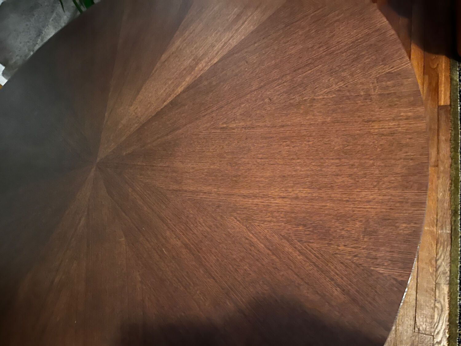 Round table made of solid wood with a walnut finish top.