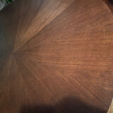 Round table made of solid wood with a walnut finish top.