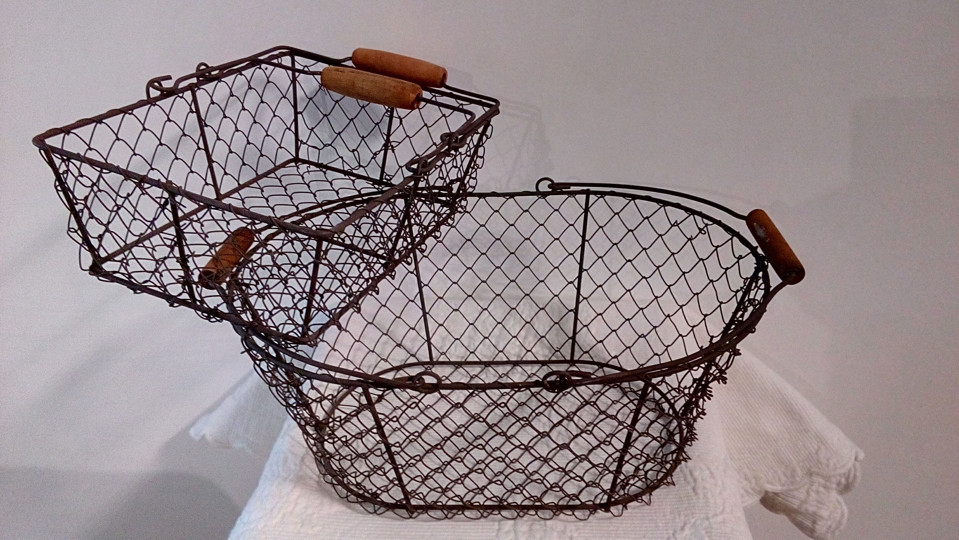 Duo of aged metal mesh baskets