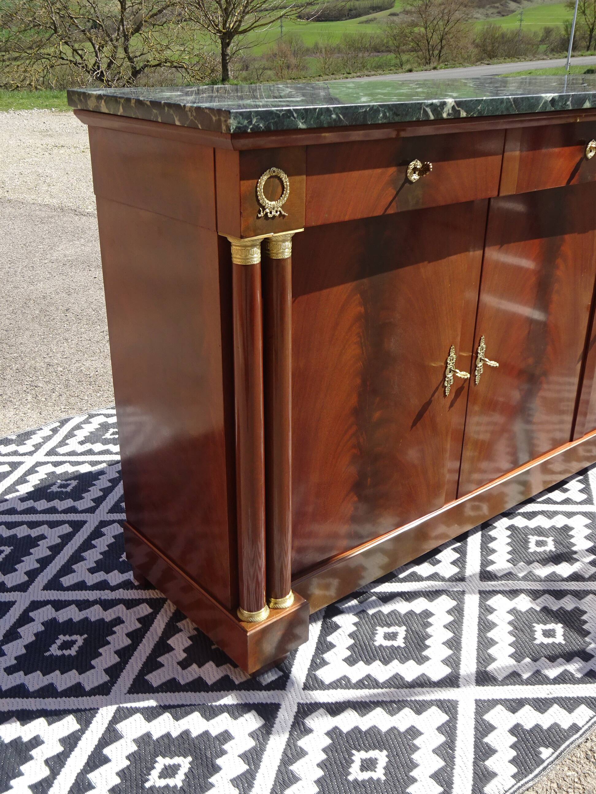 Flamed mahogany enfilade with sea green marble in Empire style.