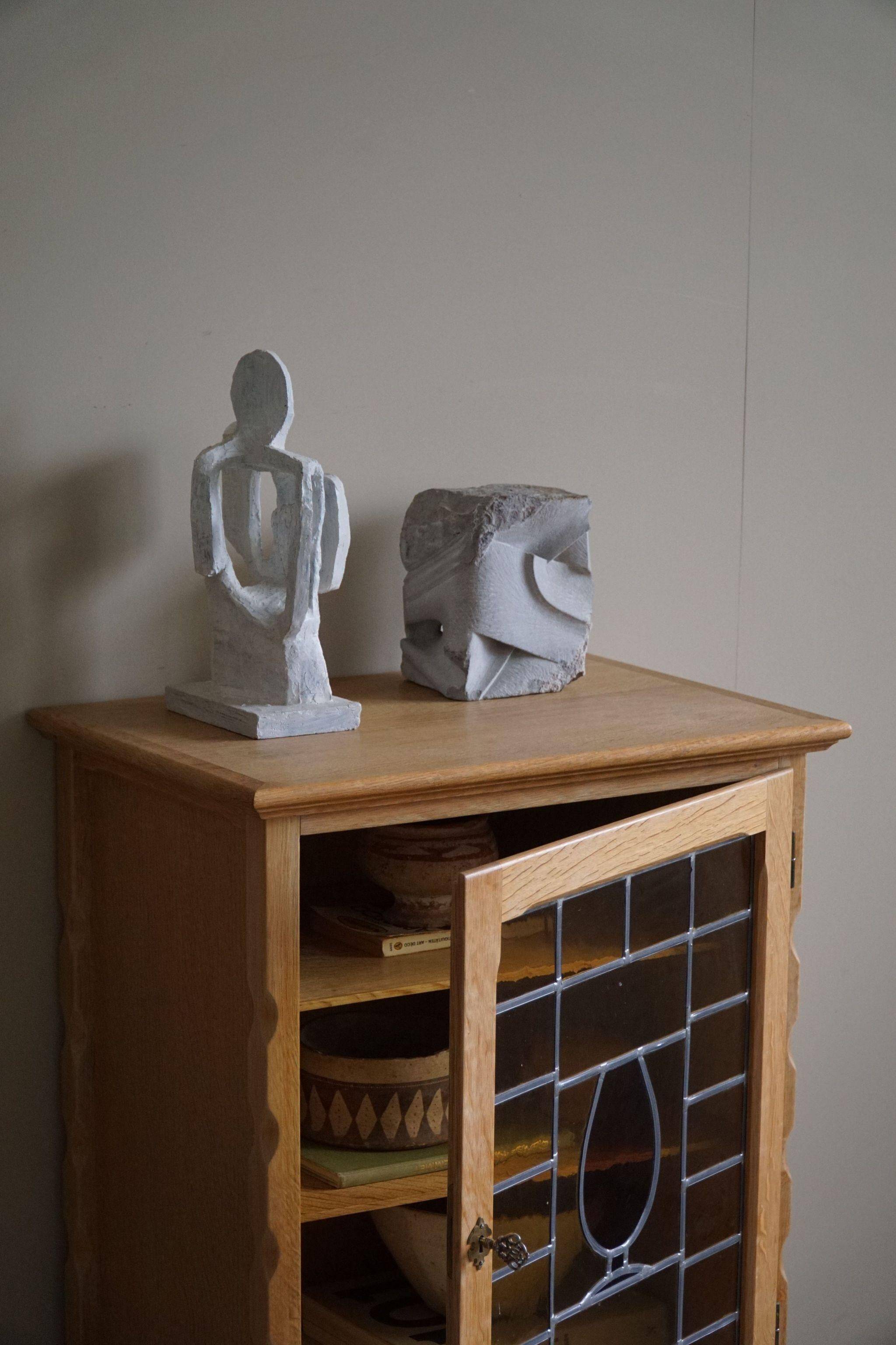 Scandinavian wardrobe in natural oak with a glass front.