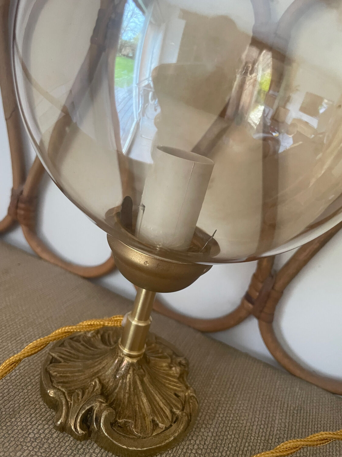 2 bedside lamps with round amber glass globes and gold metal.