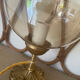 2 bedside lamps with round amber glass globes and gold metal.