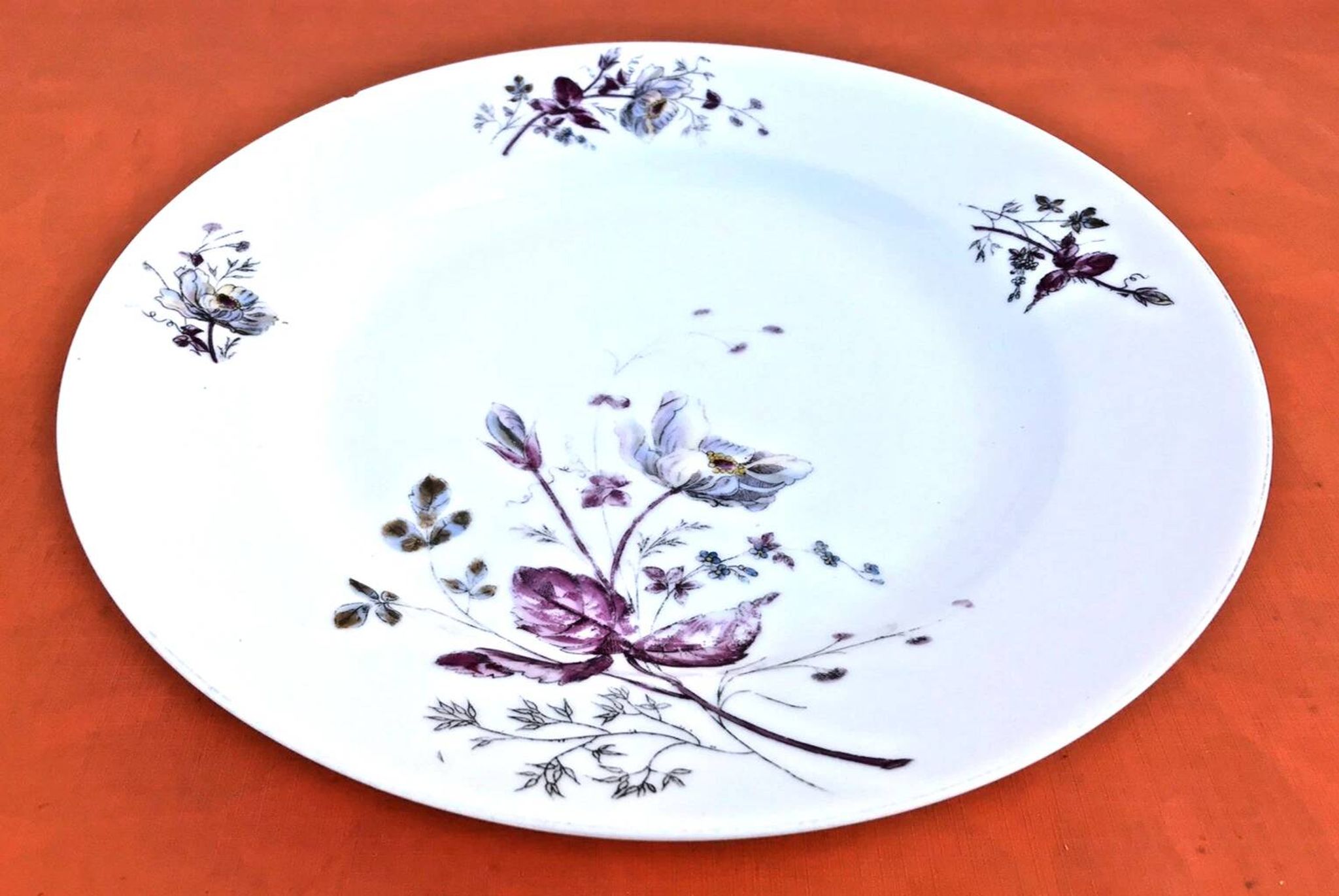 Antique white porcelain shallow dish with floral decoration.