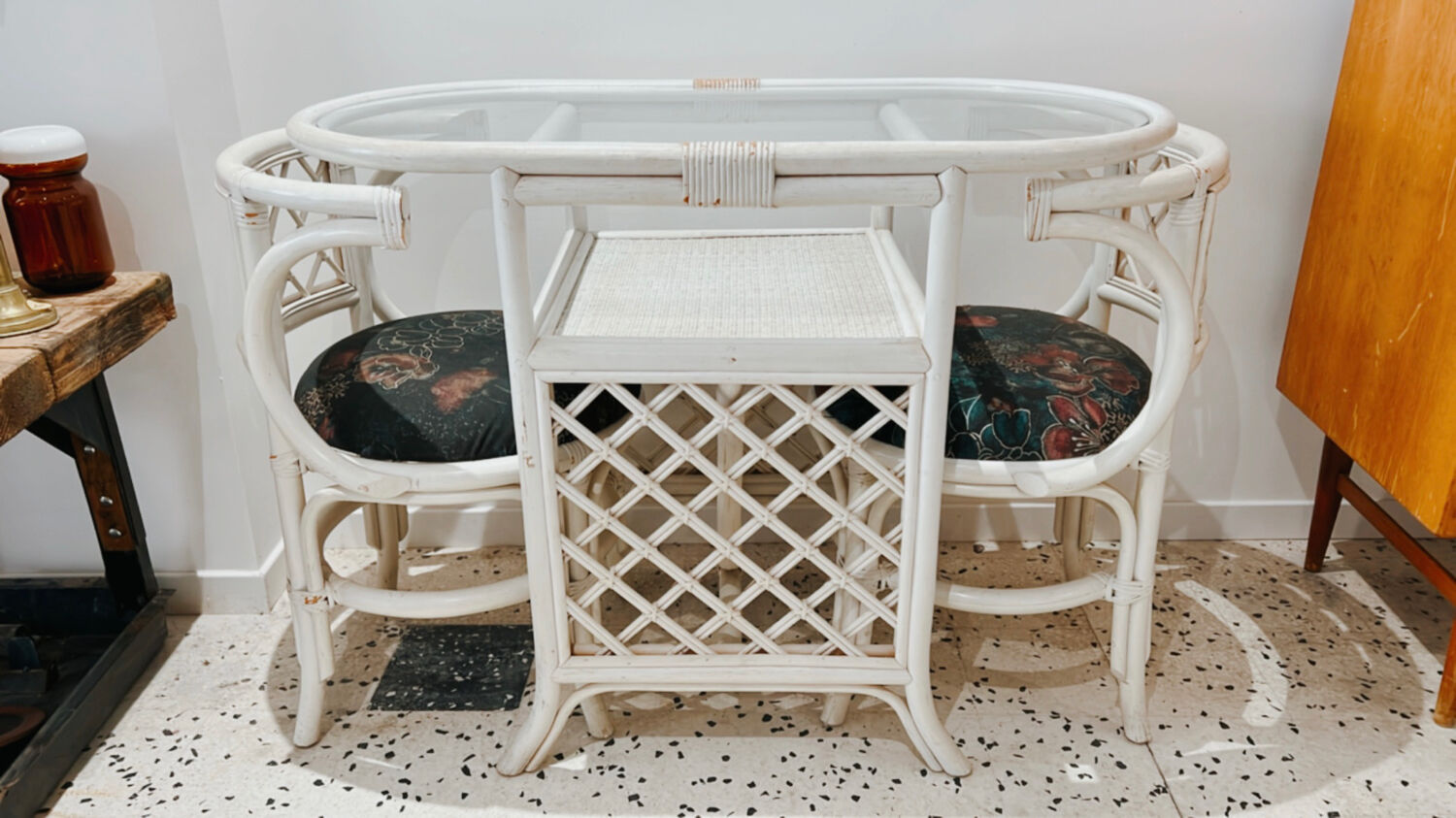 Rattan head-to-head table with vintage armchairs