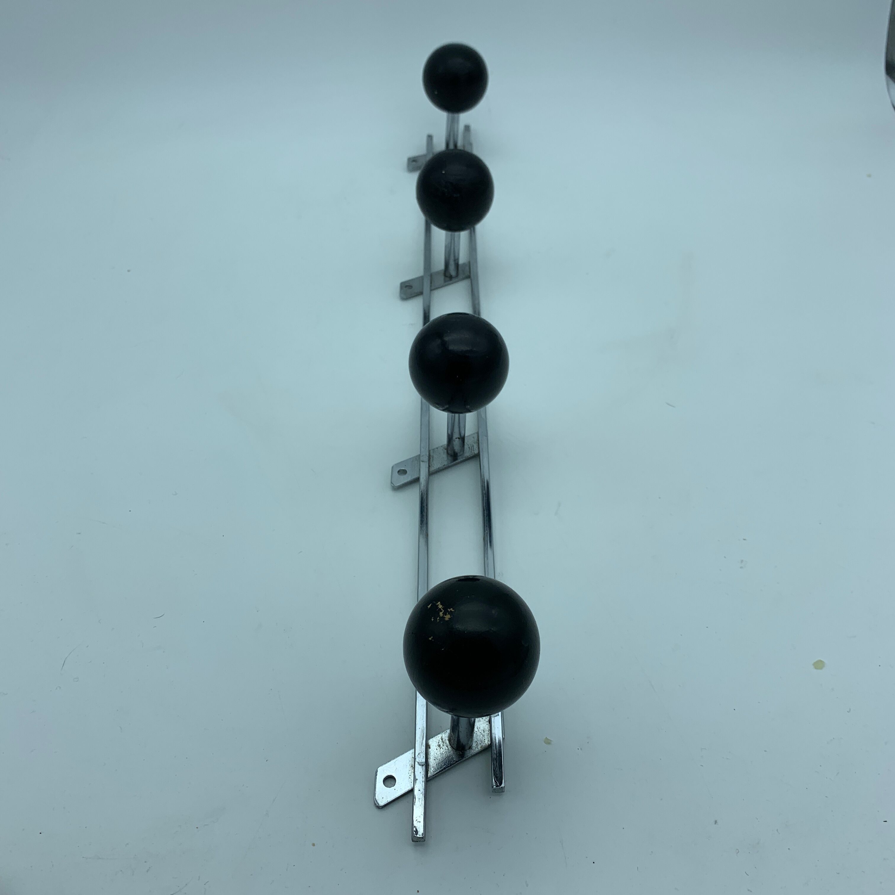Coat holder 4 chrome steel pateres and black wooden balls