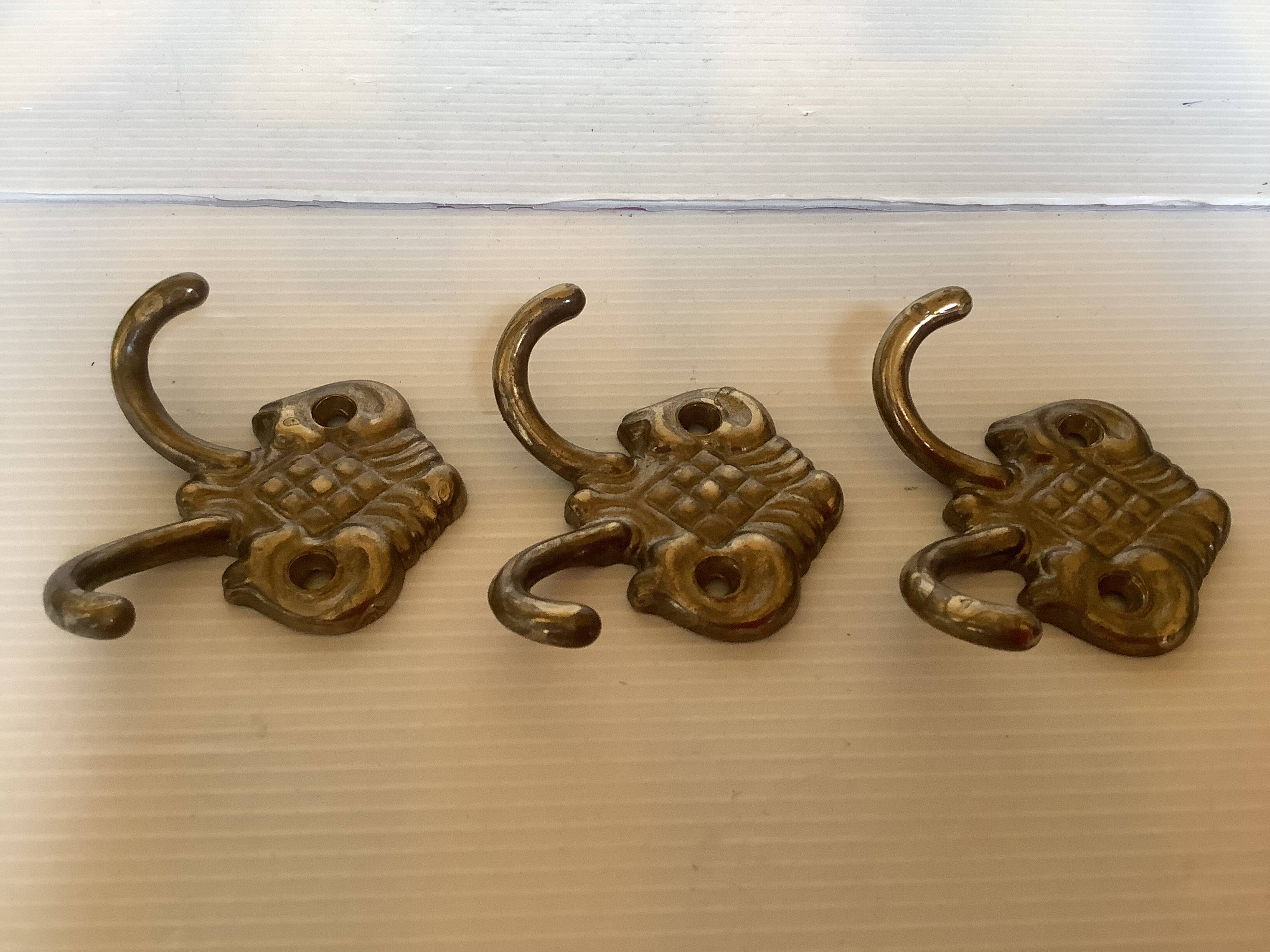 Three double brass coat hooks.