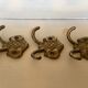 Three double brass coat hooks.