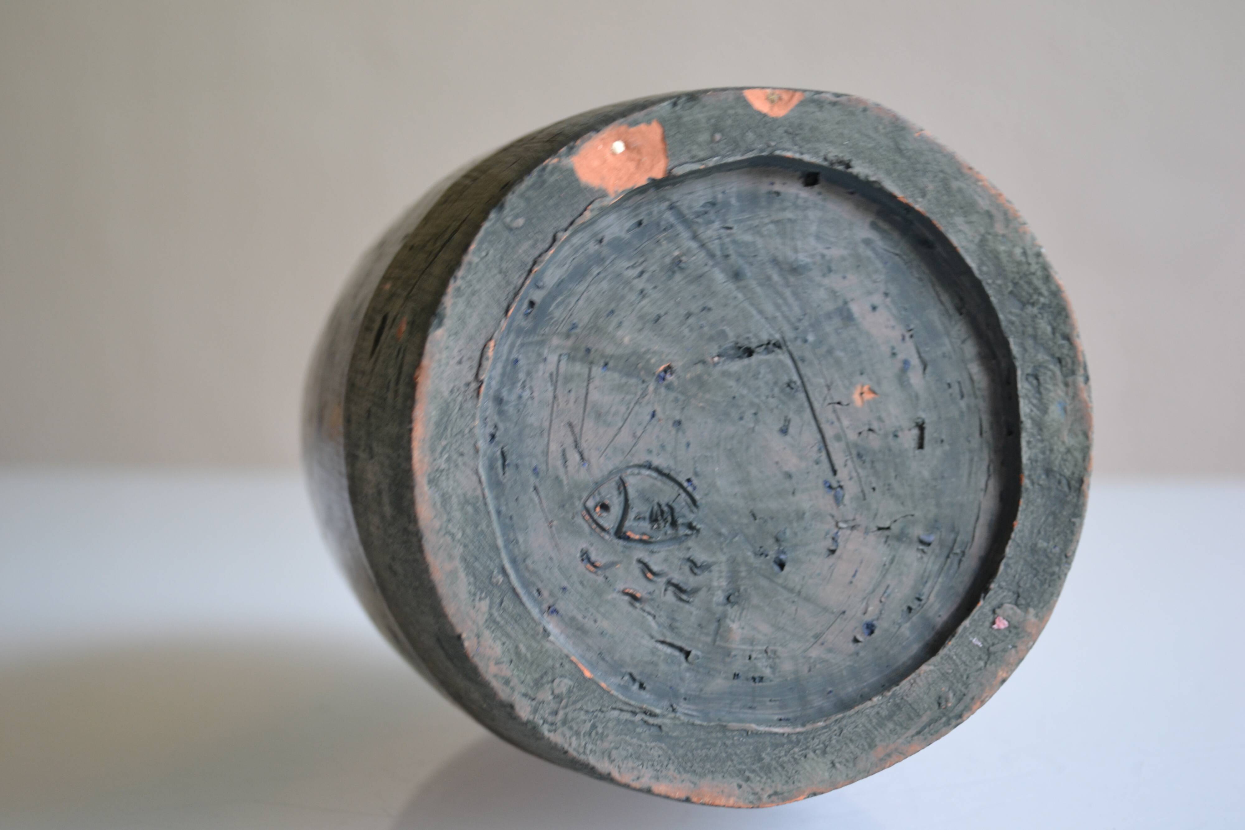 Ceramic bottle vase with a fish signature to be identified.